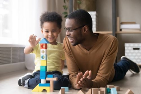 father and son playing with blocks