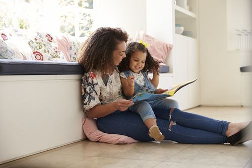 mother and daughter reading a book